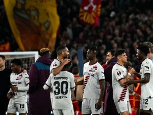Bayer Leverkusen players congratulate each other after winning 0-2 the UEFA Europa League semi final first leg football match between AS Roma and Bayer Leverkusen at the Olympic stadium on May 2, 2024 in Rome. (Photo by Alberto PIZZOLI / AFP)