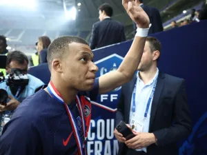Paris Saint-Germain's French forward #07 Kylian Mbappe waves goodbye to PSG supporters after playing his final match for Paris Saint-Germain (PSG) at the end of the French Cup Final football match against Olympique Lyonnais (OL) at the Stade Pierre-Mauroy, in Villeneuve-d'Ascq, northern France on May 25, 2024. The game was the club's top scorer's 308th and final appearance for his hometown club, for whom he signed in August 2017 from Monaco in a 180 million-euro deal. (Photo by FRANCK FIFE / AFP)