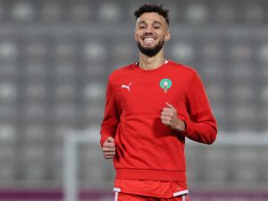 Morocco's defender #03 Noussair Mazraoui smiles during a training session at the Al Duhail SC Stadium in Doha on December 9, 2022, on the eve of the Qatar 2022 World Cup quarter-final football match between Morocco and Portugal. (Photo by KARIM JAAFAR / AFP)