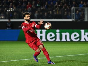 Liverpool's Egyptian forward #11 Mohamed Salah celebrates after scoring a penalty kick during the UEFA Europa League quarter-final second leg football match between Atalanta BC and Liverpool FC at the Atleti Azzurri d'Italia Stadium in Bergamo, on April 18, 2024. (Photo by Isabella BONOTTO / AFP)