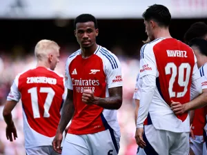 Arsenal's Brazilian defender #06 Gabriel Magalhaes celebrates scoring the team's second goal during the pre-season friendly football match for the Emirates Cup final between Arsenal and and Lyon, at the Emirates Stadium in London on August 11, 2024. (Photo by BENJAMIN CREMEL / AFP)