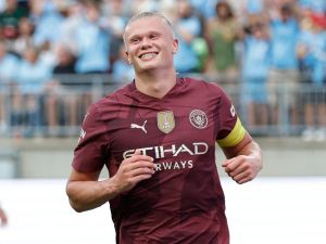 Manchester City's forward #09 Erling Haaland smiles after scoring his third goal during the second half of the pre-season club friendly football match between Chelsea FC and Manchester City FC at Ohio Stadium in Columbus, Ohio on August 3 2024. (Photo by KAMIL KRZACZYNSKI / AFP)