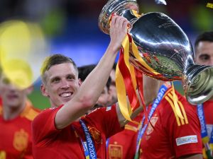Spain's forward #10 Daniel Olmo celebrates with the trophy after winning the UEFA Euro 2024 final football match between Spain and England at the Olympiastadion in Berlin on July 14, 2024. (Photo by Kirill KUDRYAVTSEV / AFP) Spain's forward #10 Daniel Olmo celebrates with the trophy after winning the UEFA Euro 2024 final football match between Spain and England at the Olympiastadion in Berlin on July 14, 2024. (Photo by Kirill KUDRYAVTSEV / AFP)