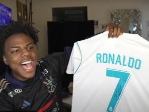 iShowSpeed holding a Ronaldo-signed jersey.
