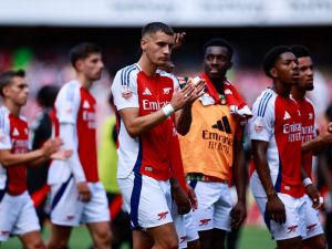 Arsenal's Polish defender #15 Jakub Kiwior applauds the fans following the pre-season friendly football match for the Emirates Cup final between Arsenal and and Lyon, at the Emirates Stadium in London on August 11, 2024. (Photo by BENJAMIN CREMEL / AFP)
