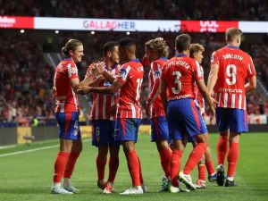 Atletico Madrid's English midfielder #04 Conor Gallagher celebrates with teammates scoring his team's first goal during the Spanish league football match between Club Atletico de Madrid and Valencia CF at the Metropolitano stadium in Madrid on September 15, 2024. (Photo by Pierre-Philippe MARCOU / AFP)