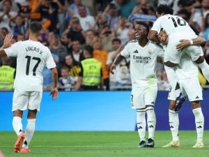 Real Madrid's French forward #09 Kylian Mbappe (R BOTTOM) celebrates with Real Madrid's Brazilian forward #16 Endrick (TOP) and Real Madrid's Brazilian forward #07 Vinicius Junior after scoring his team's fourth goal from the penalty spot during the Spanish league football match between Real Madrid CF and RCD Espanyol at the Santiago Bernabeu stadium in Madrid, on September 21, 2024. (Photo by Thomas COEX / AFP)