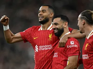 Liverpool's Egyptian striker #11 Mohamed Salah celebrates scoring the team's second goal during the UEFA Champions League league stage football match between Liverpool and Bologna at Anfield in Liverpool, north west England on October 2, 2024. (Photo by Paul ELLIS / AFP)