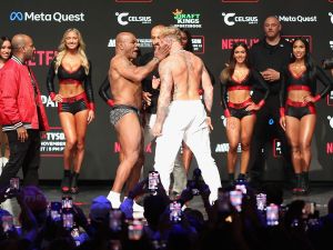 IRVING, TEXAS - NOVEMBER 14: Mike Tyson slaps Jake Paul as they face off during their ceremonial weigh-in 