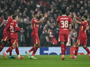 Liverpool's Dutch striker #18 Cody Gakpo (C) celebrates after scoring his team second goal during the UEFA Champions League football match between Liverpool and Bayer Leverkusen at Anfield stadium, in Liverpool, north west England, on November 5, 2024. (Photo by Paul ELLIS / AFP)