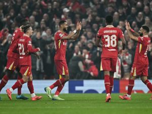 Liverpool's Dutch striker #18 Cody Gakpo (C) celebrates after scoring his team second goal during the UEFA Champions League football match between Liverpool and Bayer Leverkusen at Anfield stadium, in Liverpool, north west England, on November 5, 2024. (Photo by Paul ELLIS / AFP)