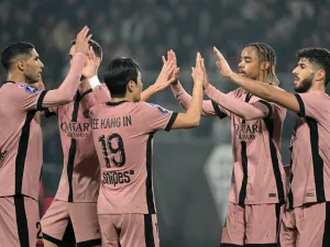 Paris Saint-Germain's French forward #29 Bradley Barcola (2-R) celebrates scoring his team's fourth goal with teammates during the French L1 football match between SCO Angers and Paris Saint-Germain (PSG) at The Raymond-Kopa Stadium in Angers, western France, on November 9, 2024. (Photo by Damien MEYER / AFP)