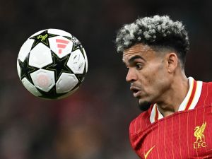 Liverpool's Colombian midfielder #07 Luis Diaz headers the ballduring the UEFA Champions League league stage football match between Liverpool and Bologna at Anfield in Liverpool, north west England on October 2, 2024. (Photo by Paul ELLIS / AFP)