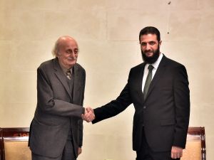 Walid Jumblatt (L), the Druze former leader of Lebanon's Progressive Socialist Party (PSP), shakes hands with Hayat Tahrir al-Sham (HTS) leader Ahmed al-Sharaa (also known as Abu Mohammad al-Jolani) during a visit to Damascus on December 22, 2024. 