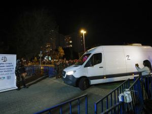Israeli soldiers salute as vehicles transporting the bodies of four hostages handed over following a ceasefire and prisoner exchange deal between Israel and Palestinian factions in Gaza, arrive to the National Center for Forensic Medicine in Tel Aviv on October 13, 2025. AFP Red Cross receives remains of Israeli hostages as Gaza handover tensions ease