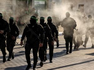 Masked members of the al-Qassam Brigades, the military wing of Hamas, march during a rally in Gaza City on July 20, 2022. (Photo by Mahmud HAMS / AFP) New era for Gaza: Independent technocrats to take the helm after faction deal