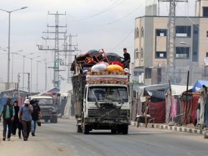 Displaced Palestinians returning to Gaza City, drive by tents used as temporary shelters in the Nuseirat refugee camp in the central Gaza Strip, on October 12, 2025. Photo by EYAD BABA / AFP East Gaza