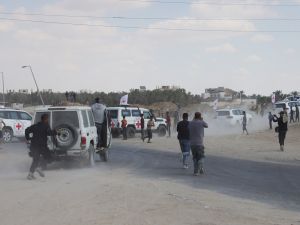 Photo by BASHAR TALEB / AFP / Palestinian photographers take pictures of vehicles of the International Committee of the Red Cross (ICRC) as they take off with the 13 living hostages handed over by Hamas in the south of Deir el-Balah in the central Gaza Strip, on October 13, 2025. Ceasefire on Edge: Washington split over Hamas’ handling of Israeli hostages