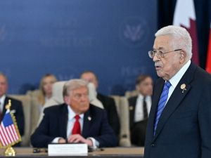 Photo by SAUL LOEB / AFP Palestinian President Mahmud Abbas (R) walks past US President Donald Trump during a summit on Gaza in Sharm el-Sheikh on October 13, 2025. Abbas issues new decree outlining presidential succession in Palestine