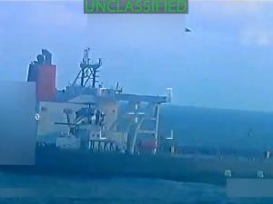 As US fleet nears, Iran fires off first major threat