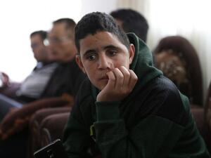Palestinian Mohammed al-Tamimi, 15, sits at his family home in the West Bank city of Ramallah on Feb. 27, 2018. Mohammed, who is the cousin of jailed teenager Palestinian activist Ahed Tamimi, was shot in the head with a rubber bullet in December leaving him with permanent damage to his skull, relatives say. 
(ABBAS MOMANI / AFP) Palestinian Mohammed al-Tamimi, 15, sits at his family home in the West Bank city of Ramallah on Feb. 27, 2018. Mohammed, who is the cousin of jailed teenager Palestinian activist Ahed Tamimi, was shot in the head with a rubber bullet in December leaving him with permanent damage to his skull, relatives say. 
(ABBAS MOMANI / AFP)