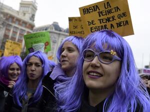 Woman sporting wigs attend a demonstration to defend women's rights on International Women's Day in Madrid, on Mar. 8, 2018. Spain celebrated International Women's Day today with an unprecedented general strike in defense of their rights that saw hundreds of trains cancelled and countless protests scheduled throughout the day.
(OSCAR DEL POZO / AFP)
