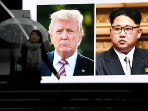 A pedestrian walks in front of a huge screen flashing a news report relating to U.S. President Donald Trump and North Korean leader Kim Jong agreeing to meet for talks in Tokyo on Mar. 9, 2018. Japan's prime minister on March 9 welcomed the surprise announcement of a summit between U.S. President Donald Trump and North Korea's Kim Jong Un by the end of May.
(Toshifumi KITAMURA / AFP)
