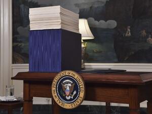 A copy of the spending bill, approved by Congress, is seen on a desk before U.S. President Donald Trump speaks about the bill in the Diplomatic Room at the White House on Mar. 23, 2018. 
(Nicholas Kamm / AFP)