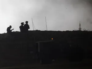 Israeli security forces are deployed near Kibbutz Nir Oz on the Israeli border with the southern Gaza Strip as smoke billows from tyres burning in the Palestinian village of Khuzaa on Apr. 6, 2018. Clashes erupted as protesters gathered along the Gaza border a week after similar demonstrations led to violence in which Israeli force killed 19 Palestinians, the bloodiest day since a 2014 war.
(Menahem KAHANA / AFP)