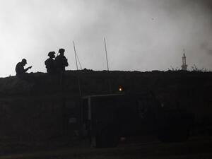 Israeli security forces are deployed near Kibbutz Nir Oz on the Israeli border with the southern Gaza Strip as smoke billows from tyres burning in the Palestinian village of Khuzaa on Apr. 6, 2018. Clashes erupted as protesters gathered along the Gaza border a week after similar demonstrations led to violence in which Israeli force killed 19 Palestinians, the bloodiest day since a 2014 war.
(Menahem KAHANA / AFP)