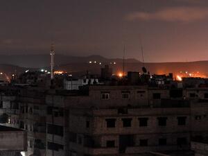 A picture taken early on Apr. 21, 2018 shows explosions appearing in the skyline of a southern district of the Syrian capital Damascus, during regime strikes targeting the Islamic State group in the Palestinian camp of Yarmouk, and neighbouring districts. 
(Rami al SAYED / AFP)