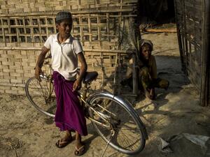 Muslim residents standing outside a shelter in Maungdaw district in Myanmar's Rakhine state near the Bangladesh border (AFP/File Photo)	
