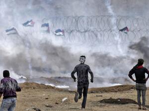 Palestinian protesters demonstrate near the fence on the Israel-Gaza border (AFP/File Photo)	