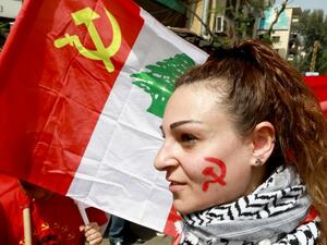 A supporter of the Lebanese Communist Party takes part in a march celebrating the International Labour Day in the Lebanese capital Beirut on May 1, 2018 / AFP