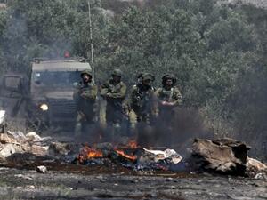 Israeli soldiers take position as Palestinian protesters clash with Israeli forces during a weekly demonstration against the expropriation of Palestinian land by Israel in the village of Kfar Qaddum, near Nablus in the occupied West Bank, on May 11, 2018. 
(JAAFAR ASHTIYEH / AFP)
