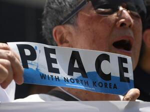 A peace activist holds a "Peace with North Korea" banner in a rally against President Donald Trump near the US Embassy in Seoul, May 25, 2018. North Korea stated it was still willing to talk to the United States after Trump cancelled a summit between the two countries, a decision that has thrown the Korean peninsula into uncertainty. (Jung Yeon-je / AFP)