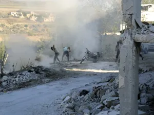 Syrians use dirt to put out a fire at the scene of a reported air strike in the district of Jisr al-Shughur, in the Idlib province, on September 4, 2018. (Zein Al RIFAI / AFP)