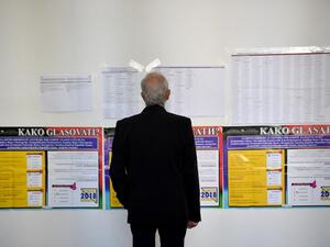 A man looks at a list of candidates at a polling station in Sarajevo on October 7, 2018 as Bosnia and Herzegovina holds it's general elections (AFP)