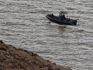 Jordanian civil defence members are seen in a boat as they search for survivors after rain storms unleashed flash floods, near the Dead Sea, in Jordan on October 26, 2018 (AFP)