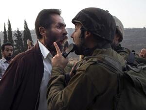 A Palestinian man argues with an Israeli soldier during clashes over an Israeli order to shut down a Palestinian school in the town of as-Sawiyah. (JAAFAR ASHTIYEH / AFP)