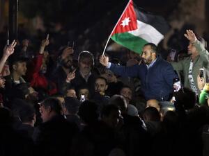 Jordanian protesters facing riot police chant slogans during a demonstration against the government's decision to raise taxes in the capital Amman
KHALIL MAZRAAWI / AFP