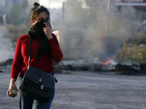 A Palestinian demonstrator covers her face during clashes with Israeli troops in Ramallah. (AFP)