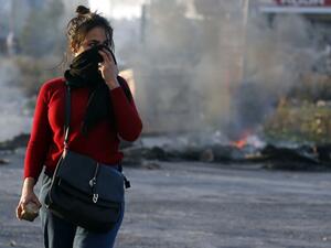 A Palestinian demonstrator covers her face during clashes with Israeli troops in Ramallah. (AFP) A Palestinian demonstrator covers her face during clashes with Israeli troops in Ramallah. (AFP)