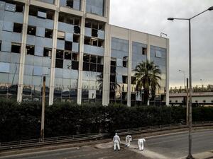 Greek police experts search for evidence after a bomb blast outside the Greece's SKAI TV building in Athens on December 17, 2018. (AFP)