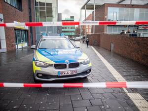 A police car in a cordoned off area at the site where a man injured four people after driving into a group celebrating the new year, in what police described as an anti-migrant attack. (AFP)