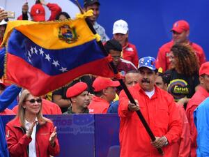 Venezuelan President Nicolas Maduro waves a national flag during a gathering with supporters to mark the 20th anniversary of the rise of power of the late Hugo Chavez. (AFP/ File)