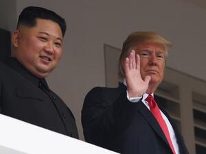 US President Donald Trump (R) waving as he and North Korea's leader Kim Jong Un (AFP)
