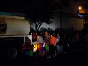 People queue for drinking water being distributed in a tanker in the municipality of Chacao in a tanker, in Caracas, on March 11, 2019.(AFP/ File Photo)