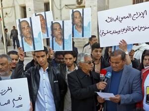 Family and tribe members of imprisoned former Libyan intelligence chief Abdullah al-Sanussi, demonstrate with signs calling for his release in Tripoli on March 23, 2019. (AFP/ File)