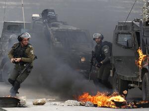 Israeli border guards move away from a burning military vehicle during clashes with Palestinian demonstrators who took to the streets on the outskirts of Ramallah in West Bank. (AFP/ File) Israeli border guards move away from a burning military vehicle during clashes with Palestinian demonstrators who took to the streets on the outskirts of Ramallah in West Bank. (AFP/ File)